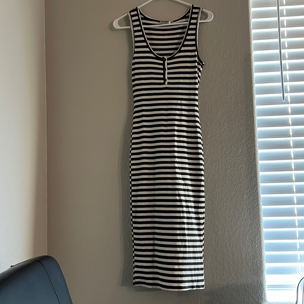 It’s a dress with olive green and white stripes and a stretchy material.